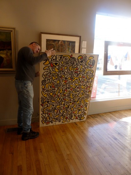 Adam Tamsky pulls out a Haynes painting