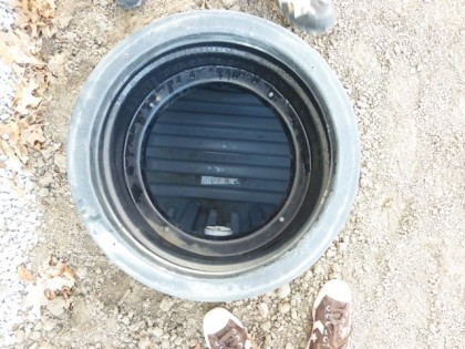 water collection tank from above, manhole cover removed