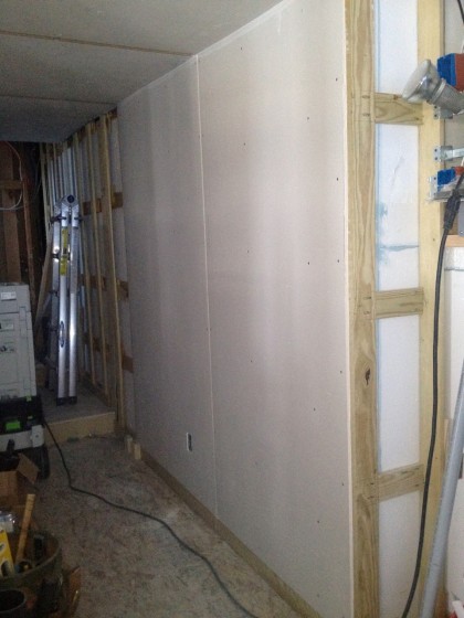 the first sheetrock goes up in the hallway