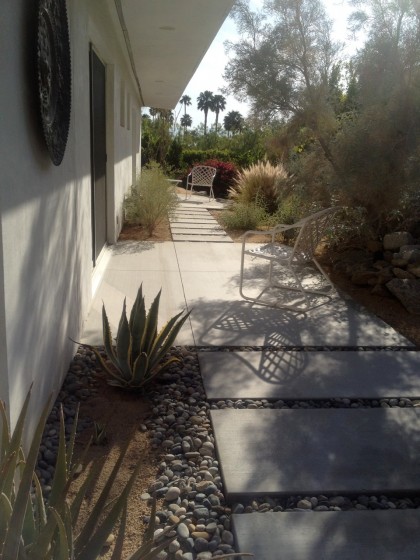 concrete with stone along the side of the house