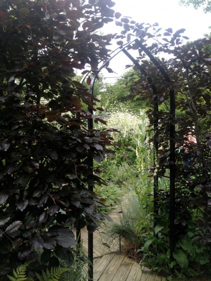 an archway leads to yet another garden room