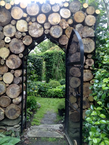 a freshly stacked log wall frames the archway