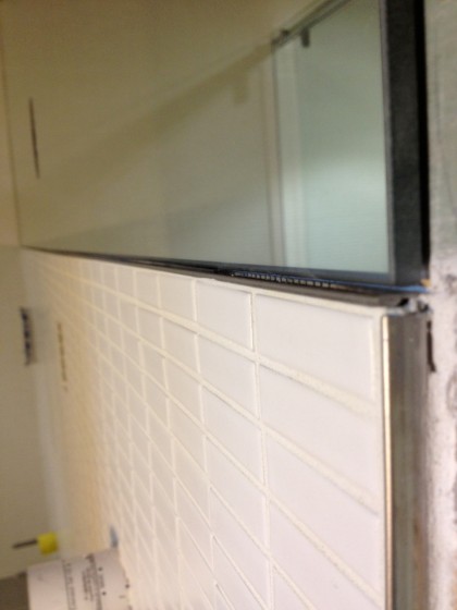 aluminum edge between tile and mirror