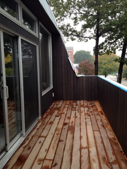 newly stained siding on the wing wall and railing